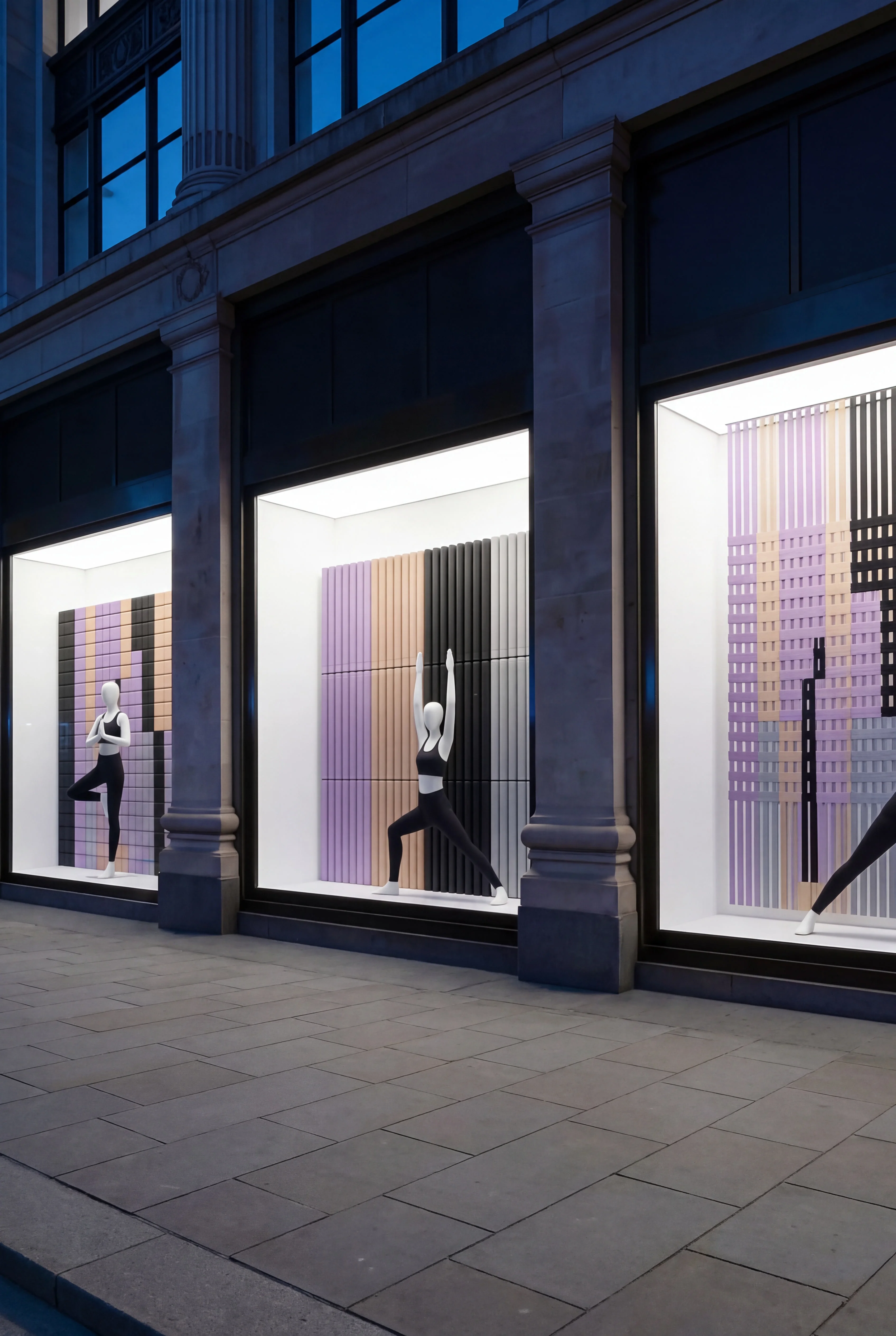 Mannequin in warrior pose within the rolled-mat display window — Spatial Design by Parallel Creative Agency — Asana Yoga & Pilates, retail