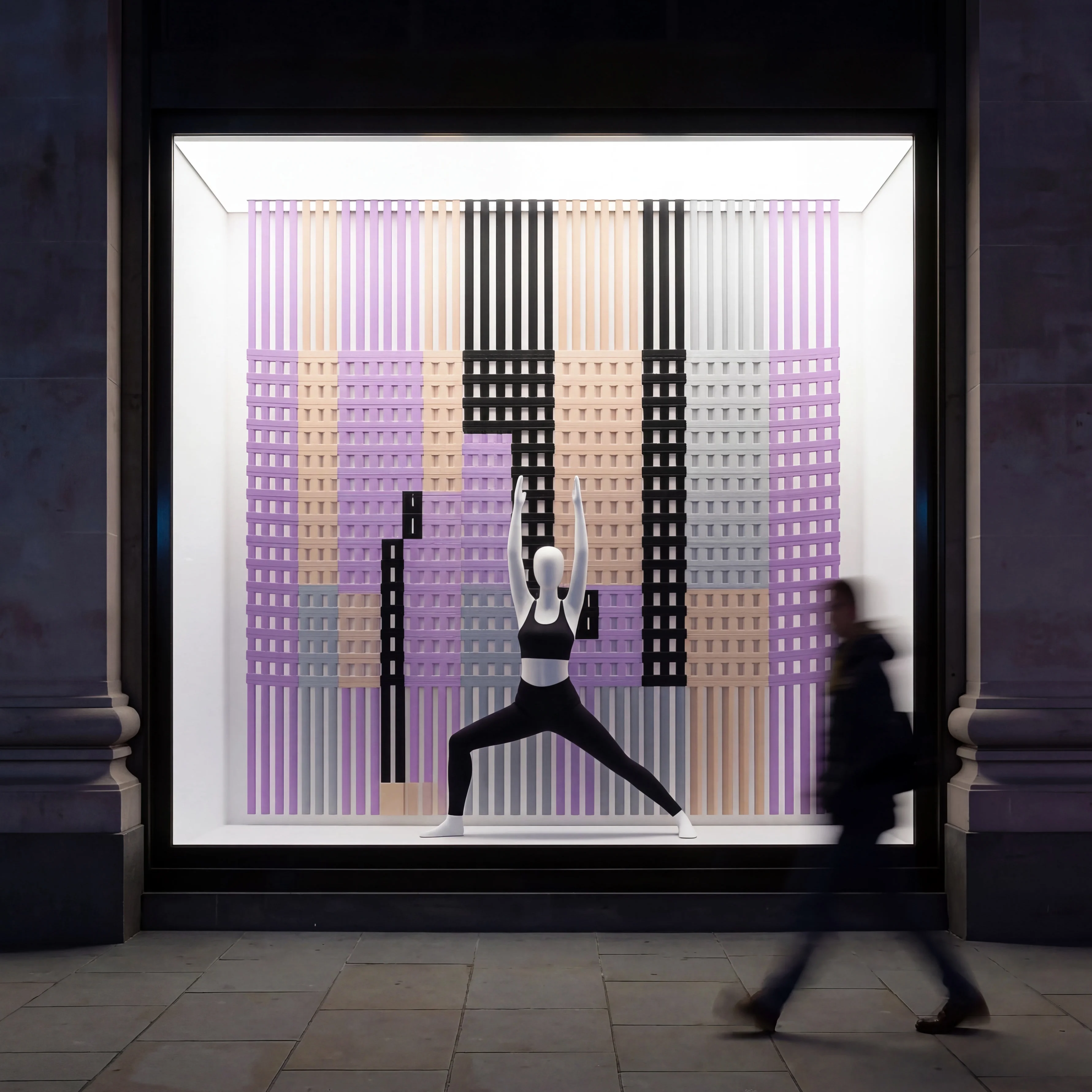 Rolled yoga mat display window with a warrior pose mannequin — Spatial Design by Parallel Creative Agency — Asana Yoga & Pilates, retail