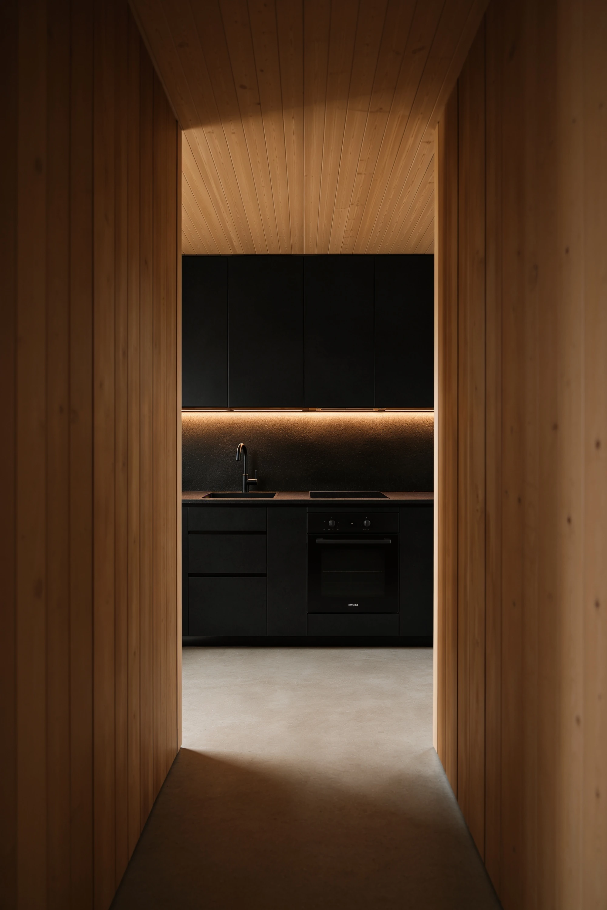 Minimal black kitchen recessed within a timber-lined micro home for compact hospitality stays — Interior Design by Parallel Creative Agency — Kabin