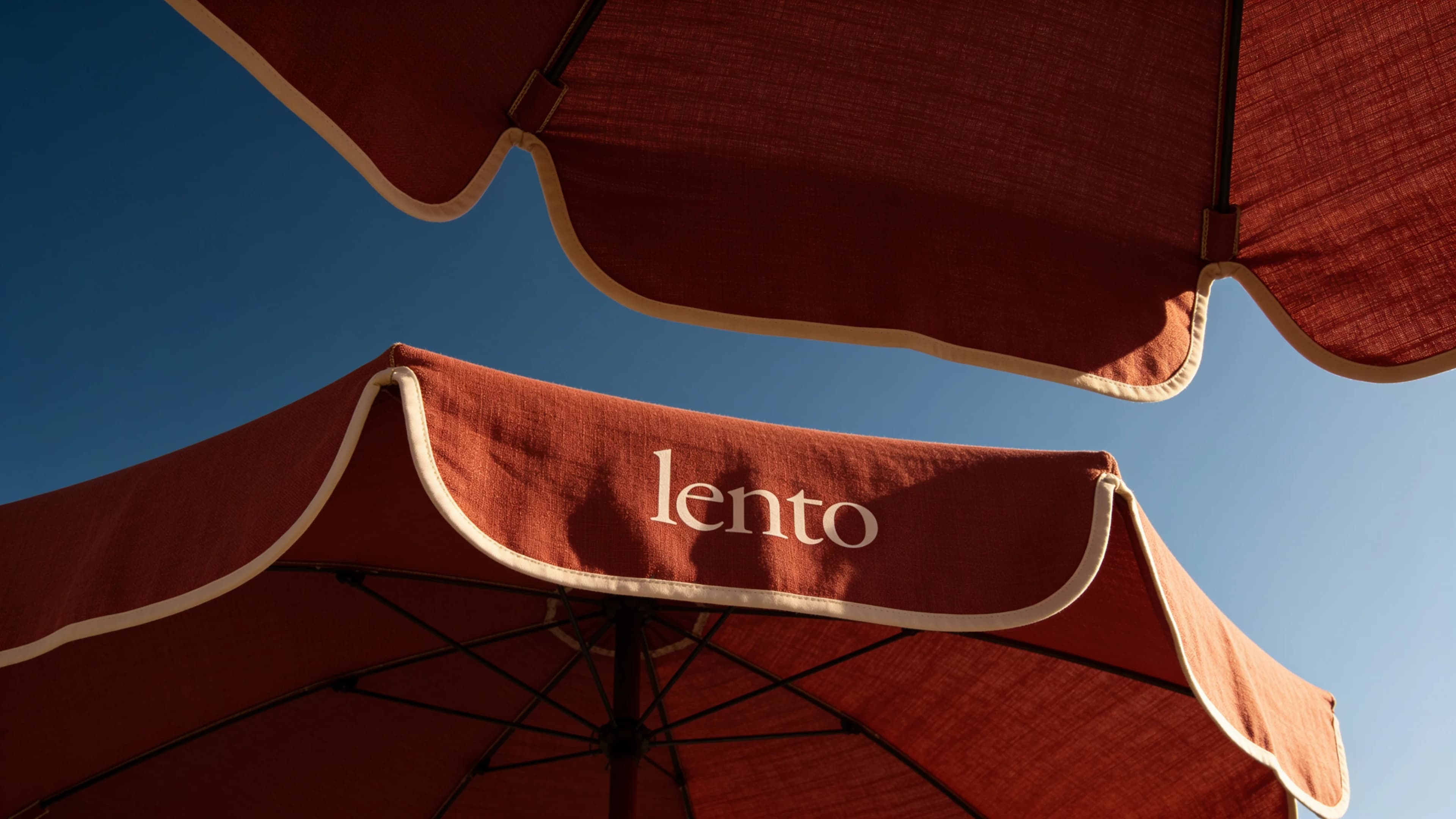 Floating timber deck with loungers and branded parasol — Hospitality Design by Parallel Creative Agency — Lento, hospitality
