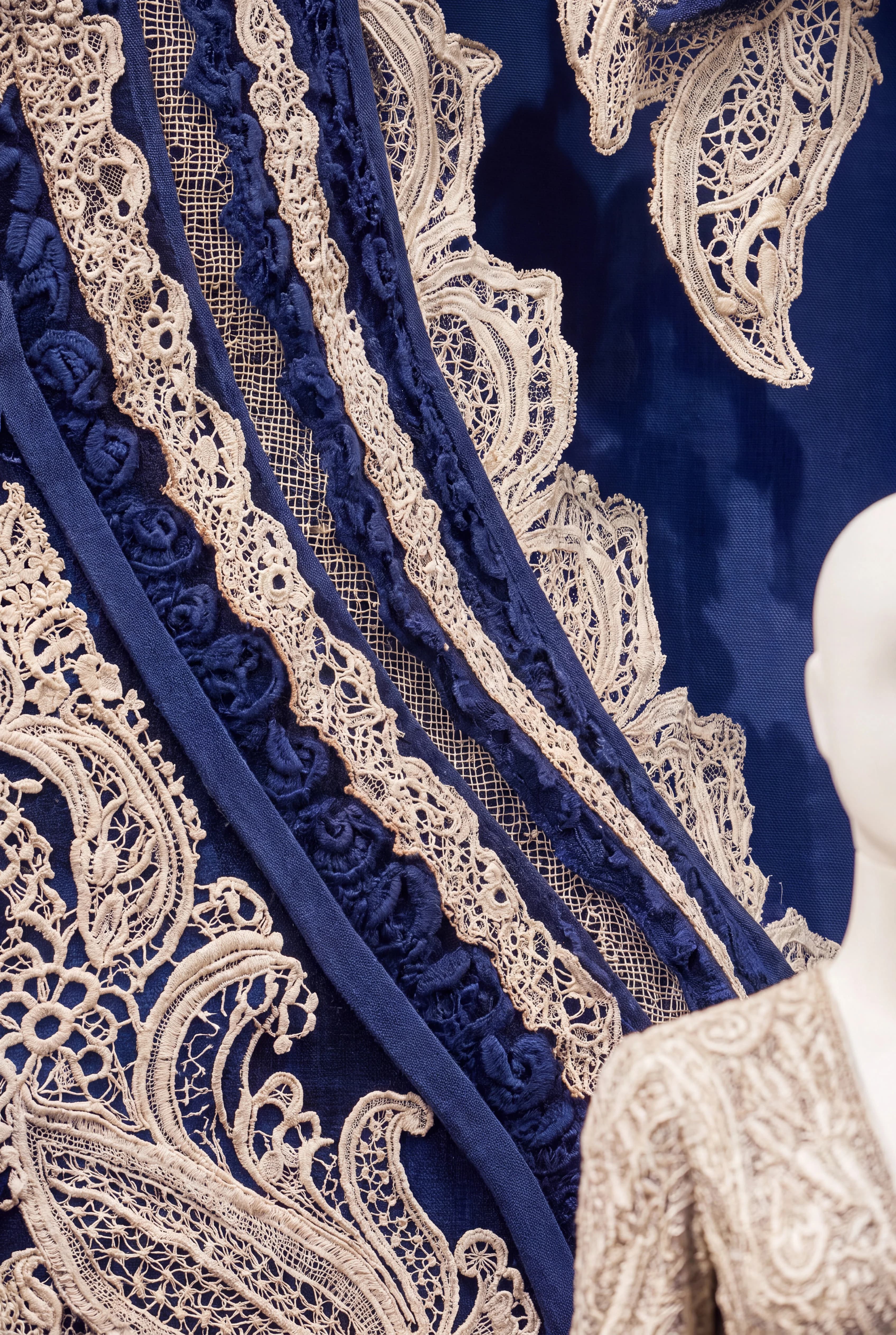 Close-up of layered blue and cream lace forming an oversized Paisley pattern — Window Concept by Parallel Creative Agency — Loom, fashion