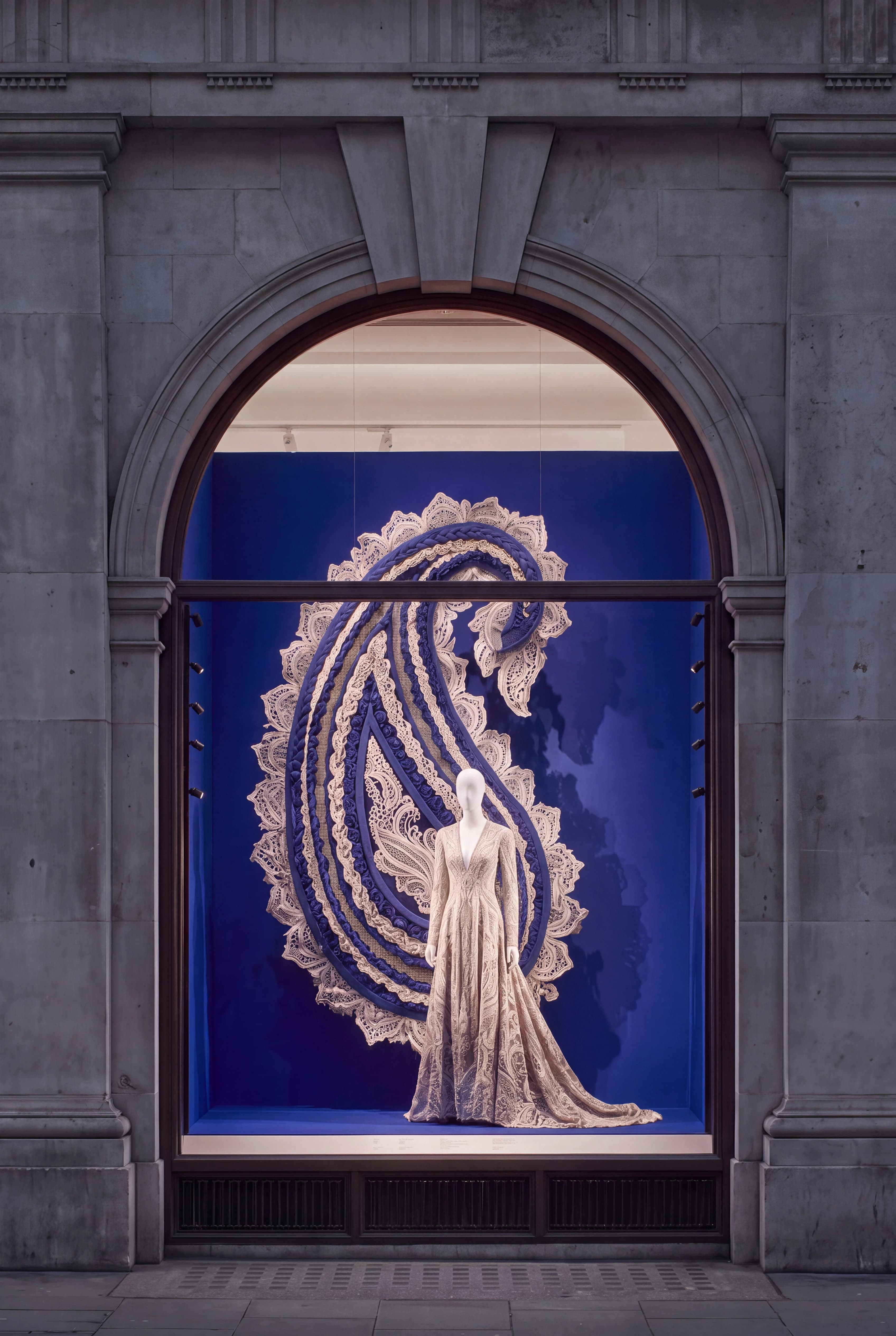 Cream gown framed by an oversized textile Paisley motif against a blue backdrop — Window Concept by Parallel Creative Agency — Loom, fashion