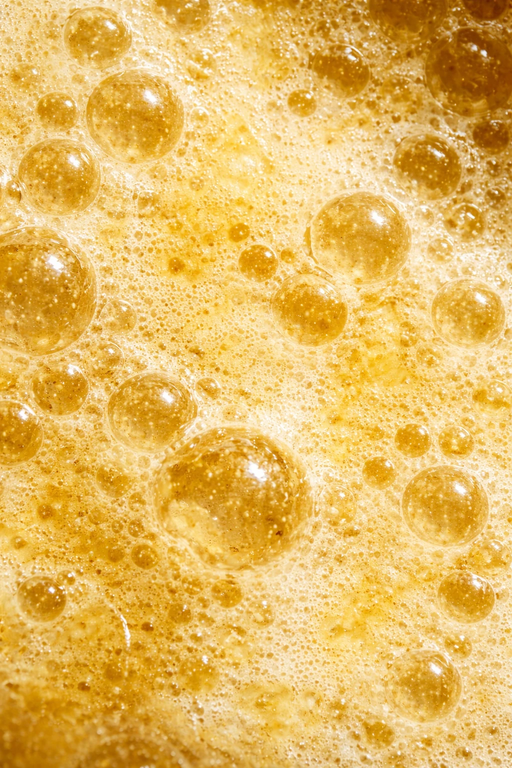 Portrait macro of golden carbonation bubbles — Product Design by Parallel Creative Agency — Love Ginger, drinks