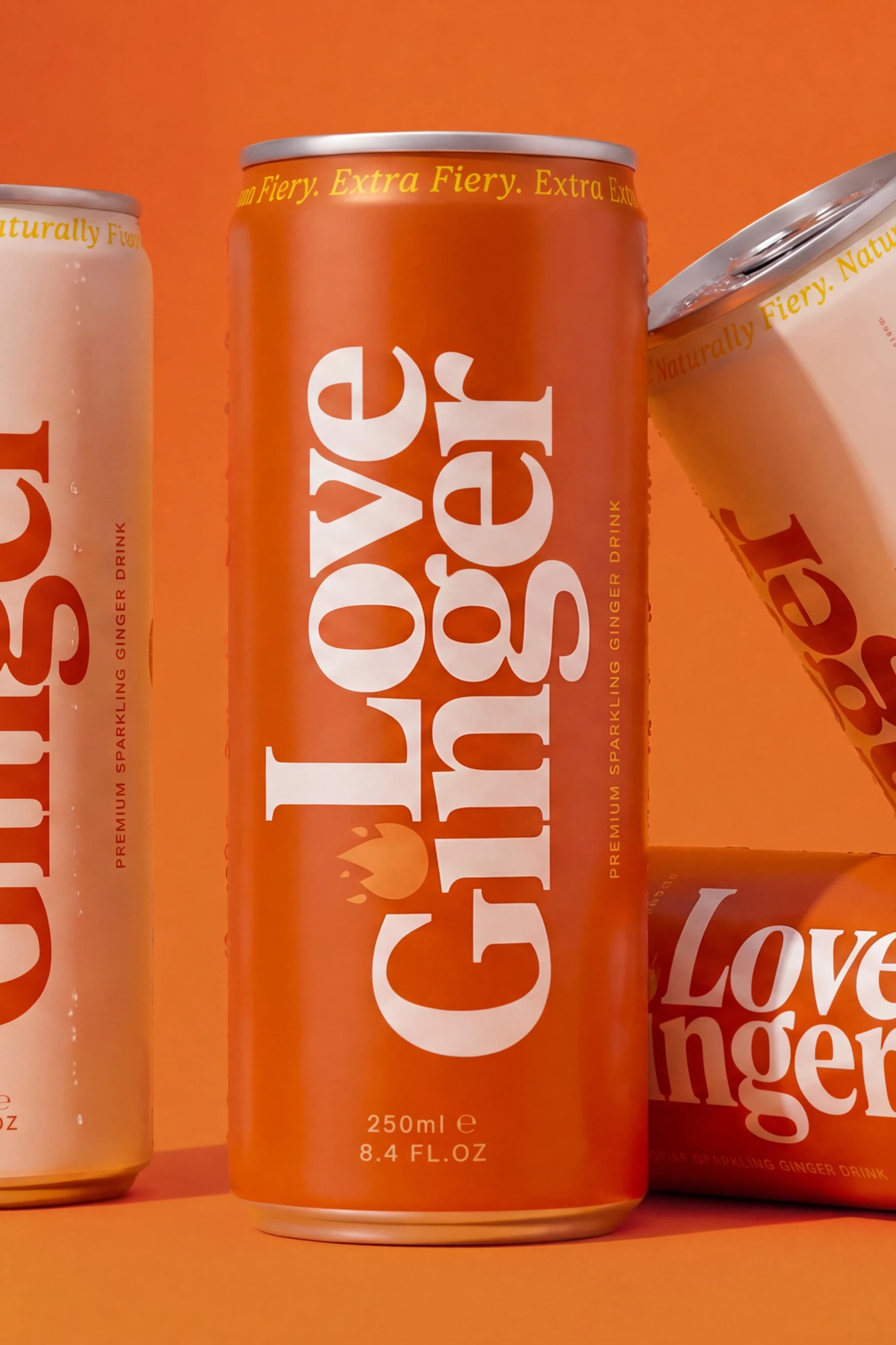 Close crop of Love Ginger cans in cream and orange colourways — Product Design by Parallel Creative Agency — Love Ginger, beverage packaging